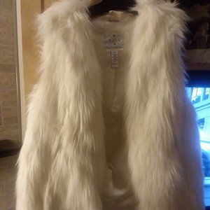 Soft fur creamy white faux fur vest. Pairs nice with a turtleneck.